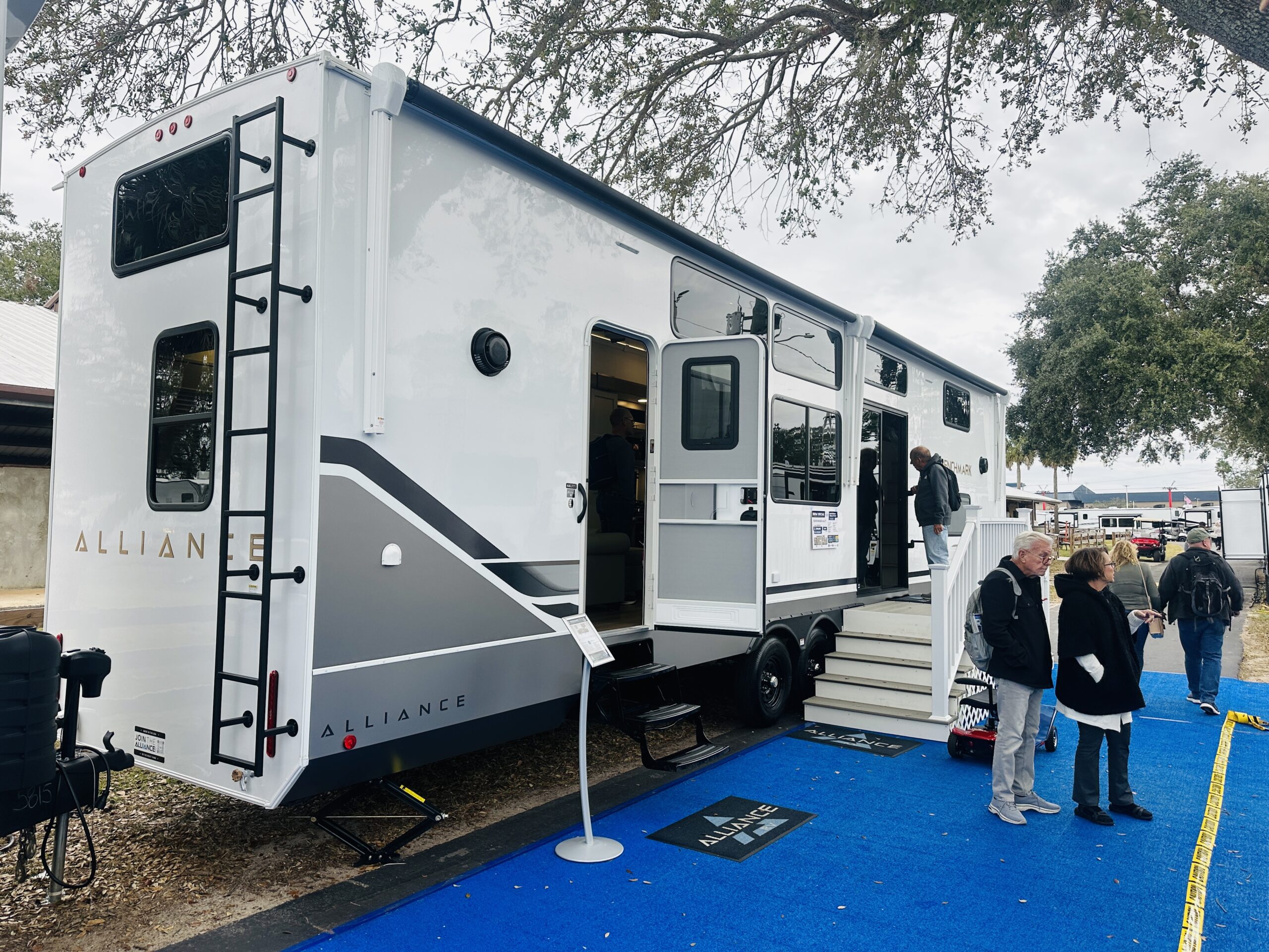 Shoppers stand outside the Aliiance destination trailer introduced at the Florida RV Supershow